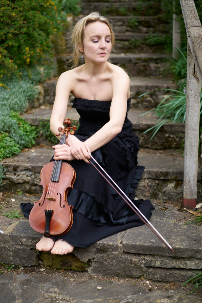 May Robertson sitting on steps holding her violin