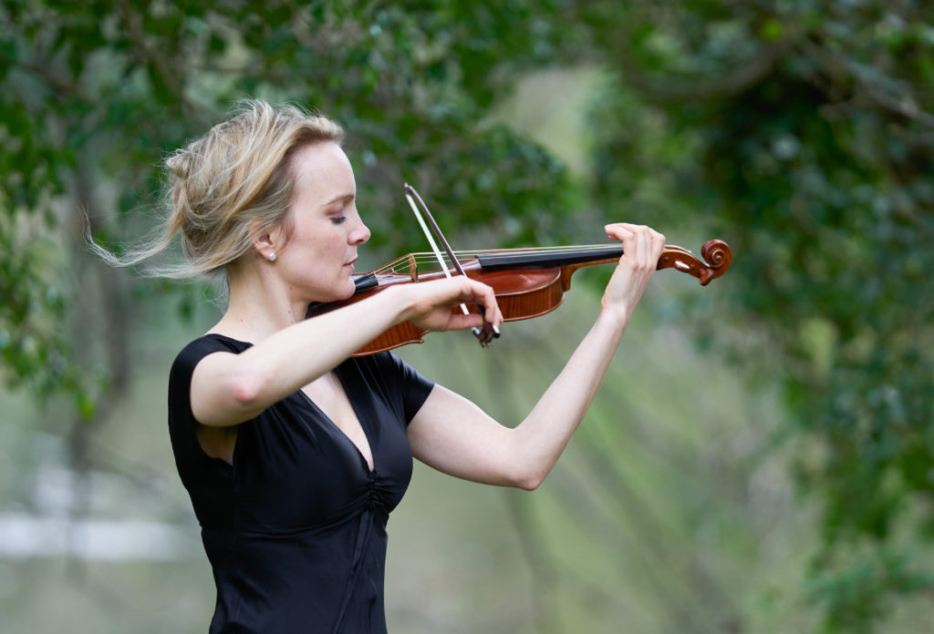 Profile of May Robertson playing the violin